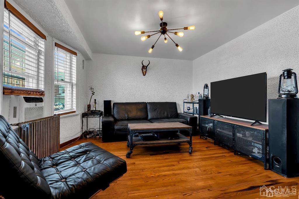 7 Downing Street Newark, NJ 07105 - Photo 3 of 18 a living room with furniture and a flat screen tv