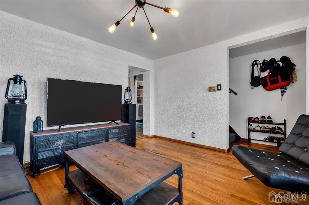 7 Downing Street Newark, NJ 07105 - Photo 4 of 18 a living room with furniture and a flat screen tv