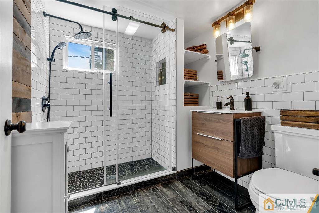 7 Downing Street Newark, NJ 07105 - Photo 5 of 18 a bathroom with a toilet a sink and shower