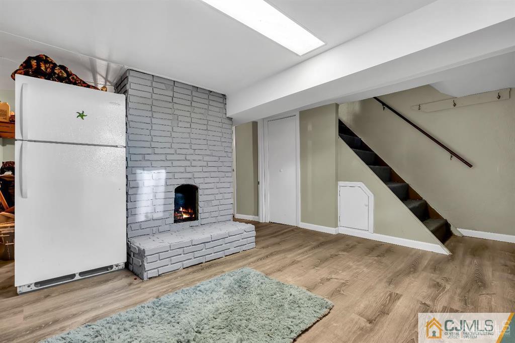7 Downing Street Newark, NJ 07105 - Photo 9 of 18 a living room with a fireplace furniture and a window