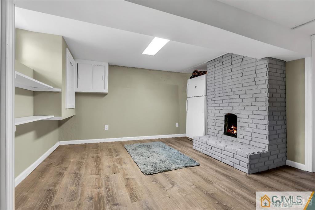 7 Downing Street Newark, NJ 07105 - Photo 10 of 18 a living room with a fireplace and a table