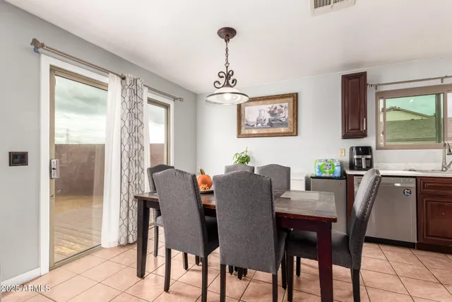 a living room with furniture kitchen view and a large window