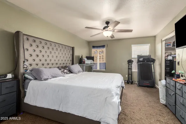 a view of walk in closet with clothes