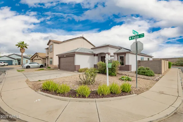 a view of a white house with a sink and garden