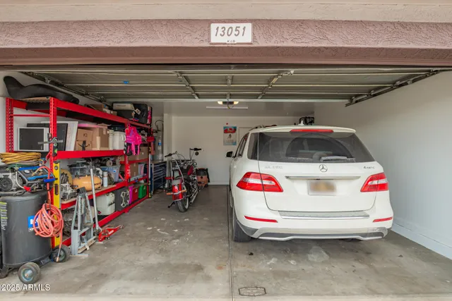 a living room with furniture a chandelier and a window