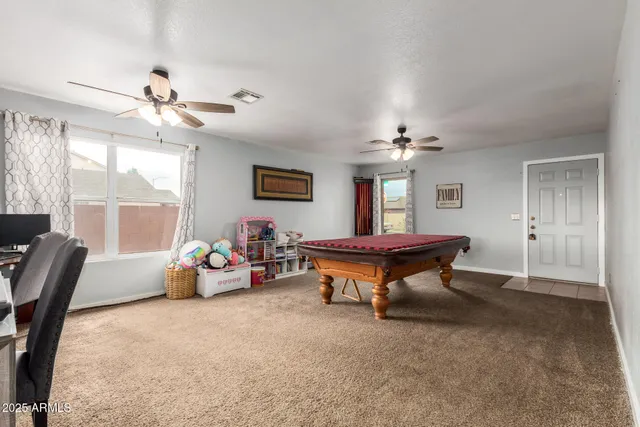 a spacious bedroom with a bed and a chandelier