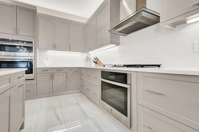 a bathroom with a granite countertop sink a toilet and bathtub