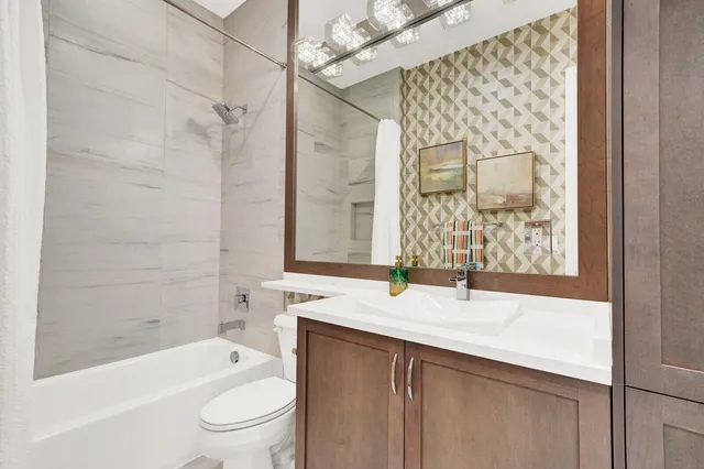 a large white bathroom with a large tub and shower