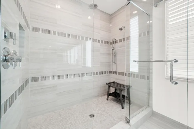 an aerial view of a house with a yard and lake view