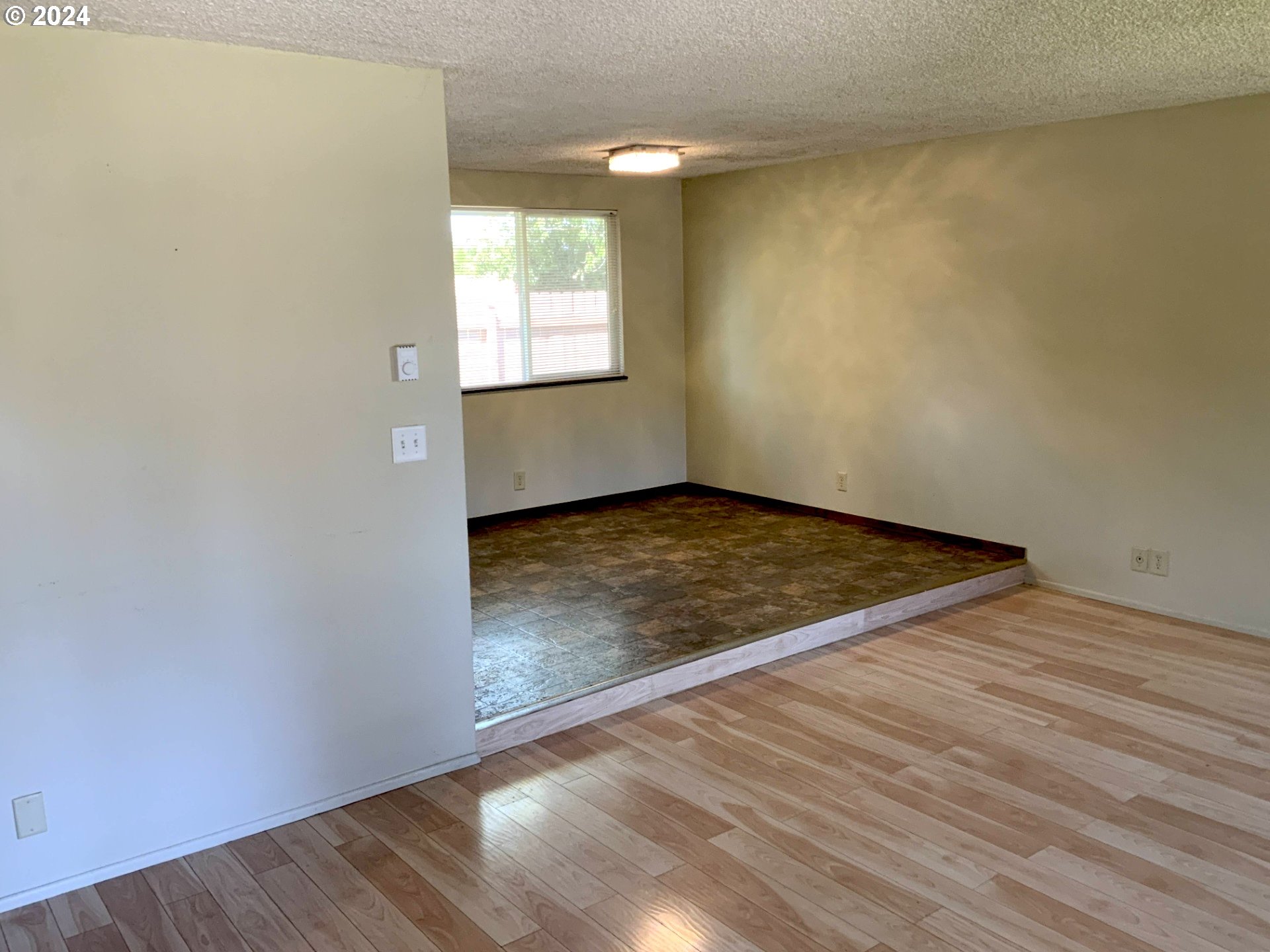 260 54th Street Springfield, OR 97478 - Photo 2 of 9 an empty room with wooden floor cabinet and windows
