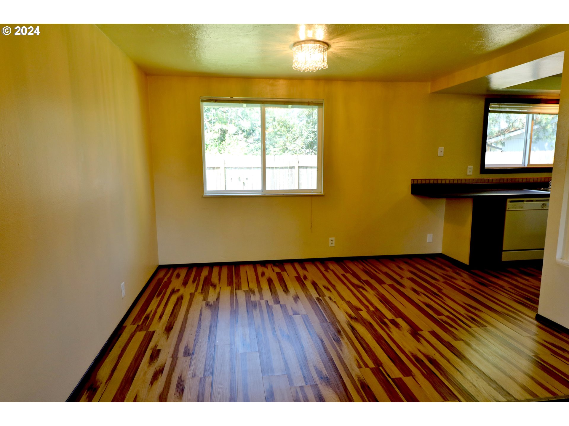 260 54th Street Springfield, OR 97478 - Photo 4 of 9 a view of an empty room with wooden floor and a window