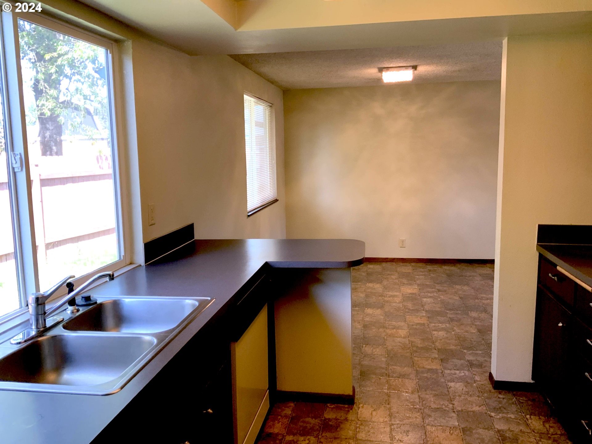 260 54th Street Springfield, OR 97478 - Photo 6 of 9 a kitchen with a sink and a refrigerator