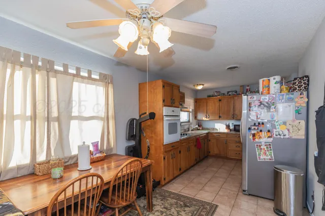 a very nice looking dining room with a large window and chandelier