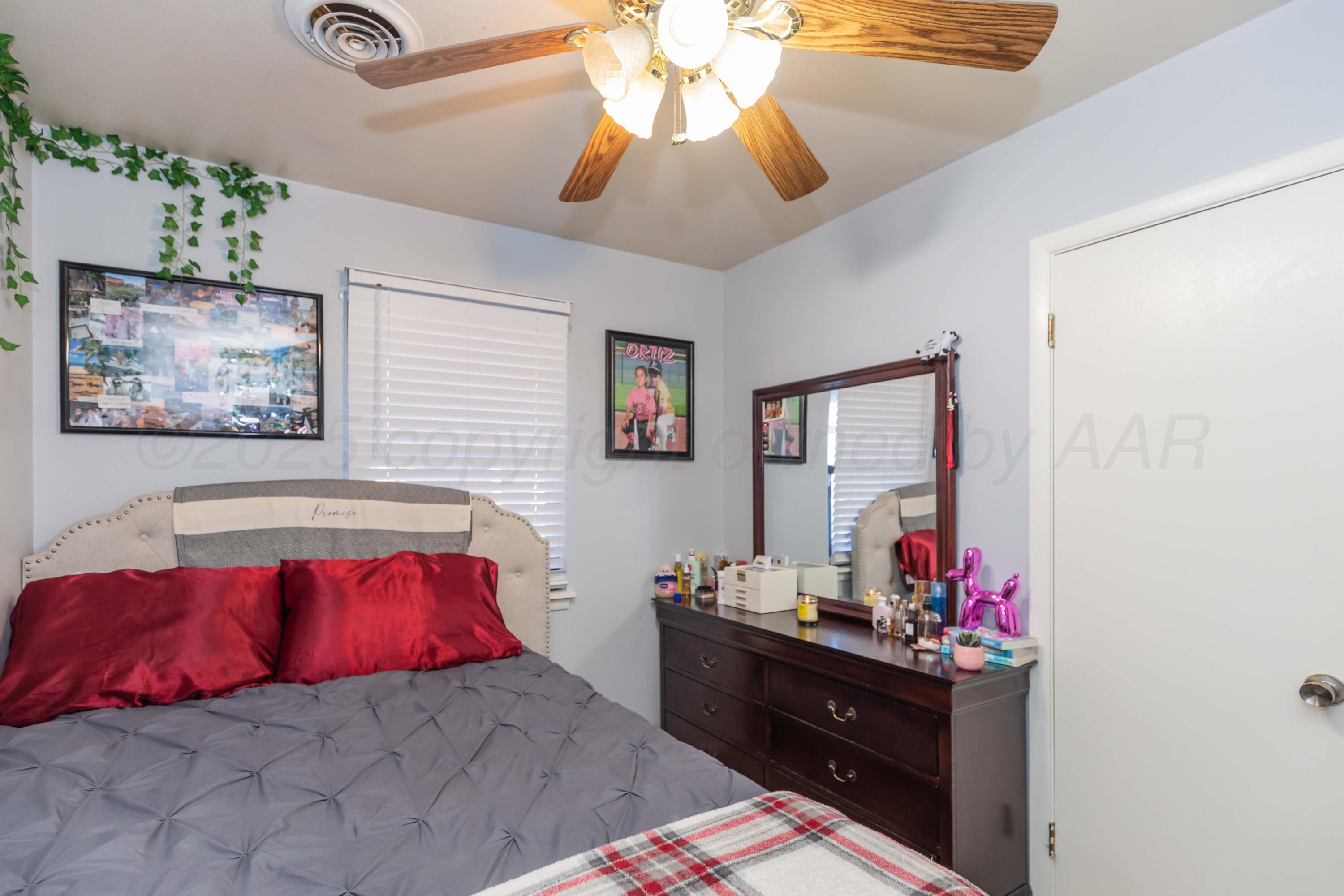 1208 Pecan Street Amarillo, TX 79107 - Photo 17 of 34 a bedroom with a bed and a dresser