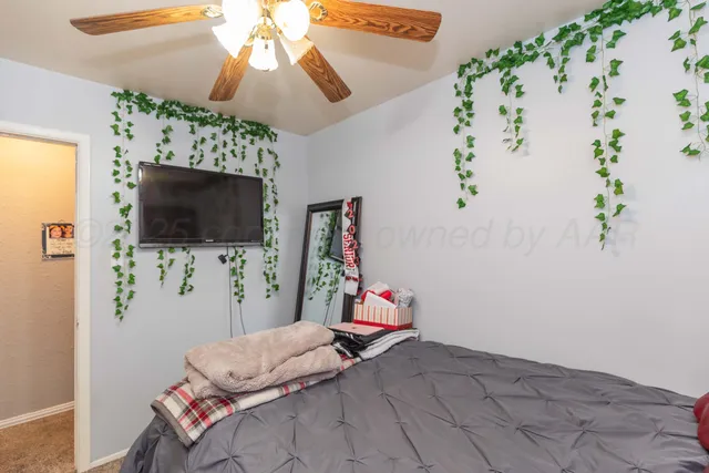 a bedroom with a bed and flat screen tv