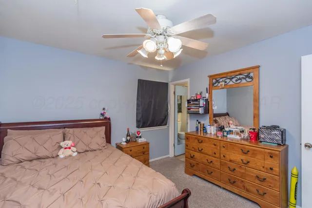 a bedroom with a bed and a dresser in it