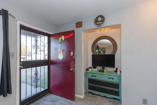 a view of a livingroom with furniture staircase and a flat screen tv