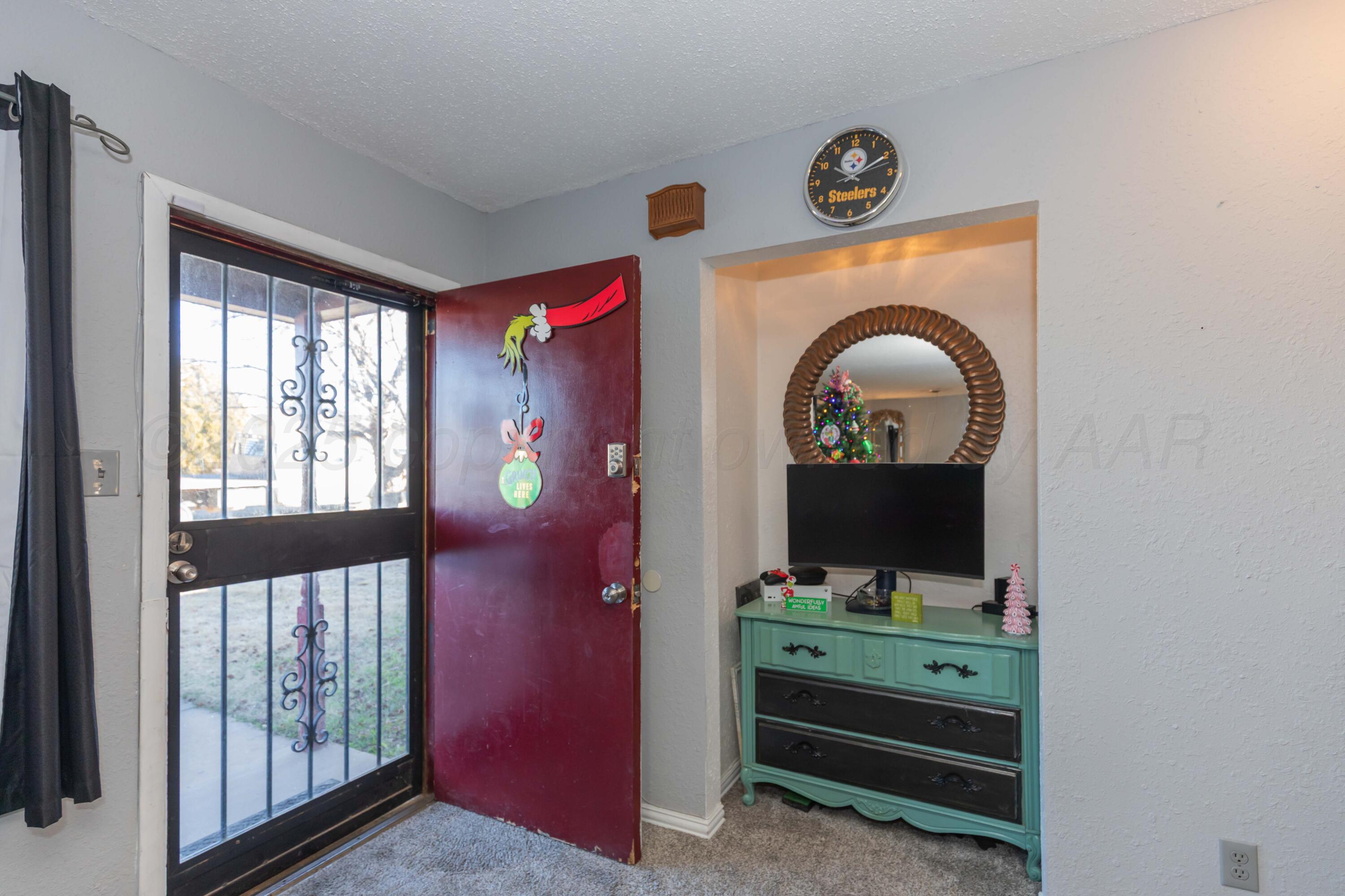 1208 Pecan Street Amarillo, TX 79107 - Photo 3 of 34 a view of a livingroom with furniture staircase and a flat screen tv