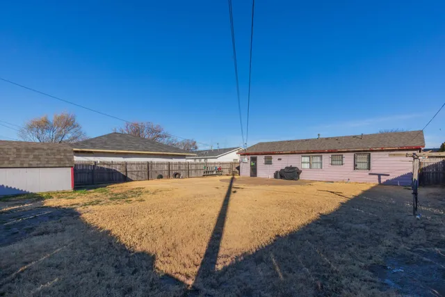 a view of a house with pool and sitting area