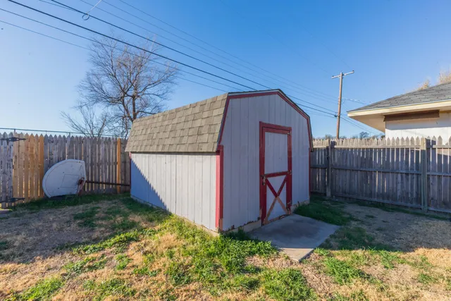 a view of a backyard with wooden fence