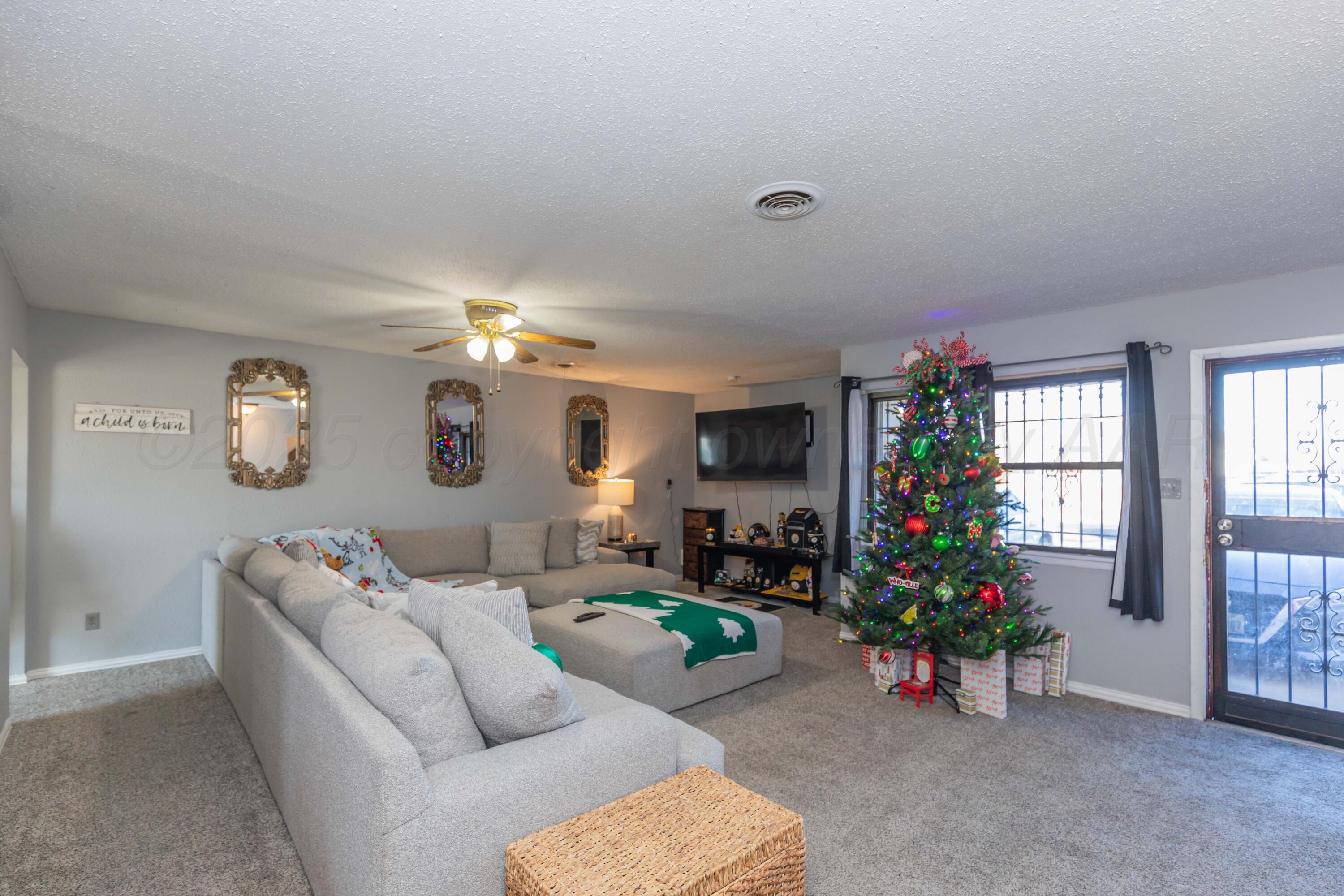 1208 Pecan Street Amarillo, TX 79107 - Photo 4 of 34 a living room with furniture and a large window