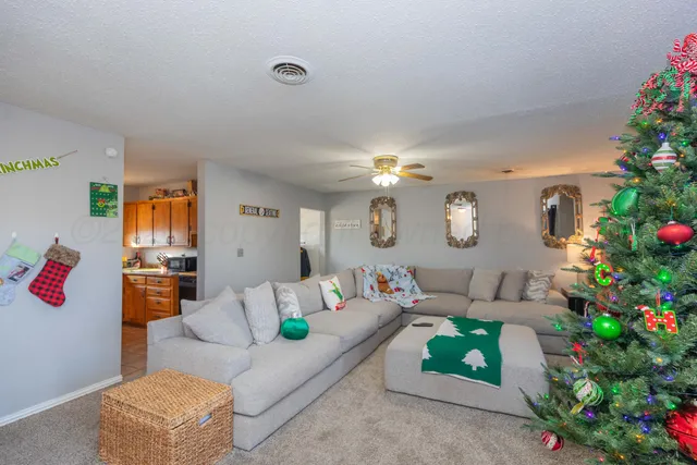 a living room with furniture and flowers