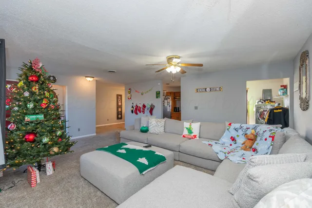 a living room with furniture and flowers