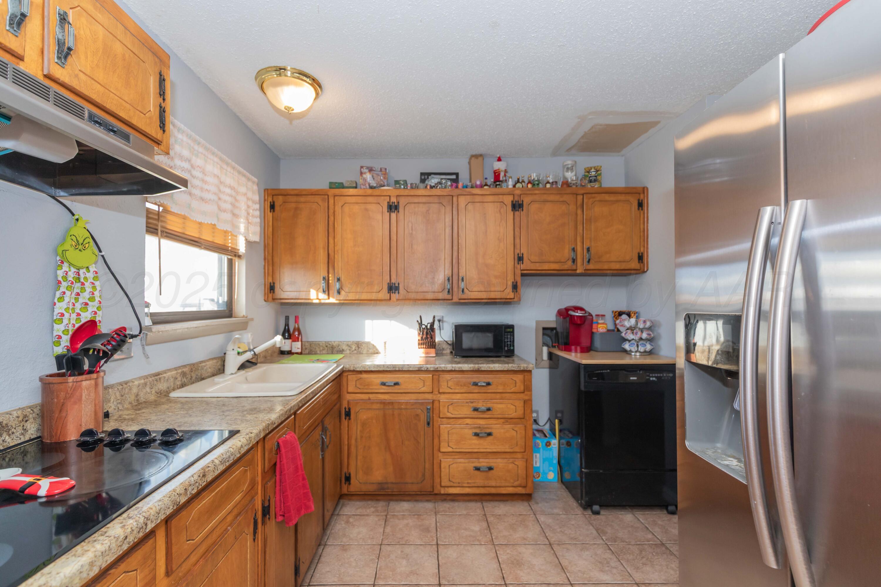 1208 Pecan Street Amarillo, TX 79107 - Photo 8 of 34 a kitchen with a sink stove and refrigerator