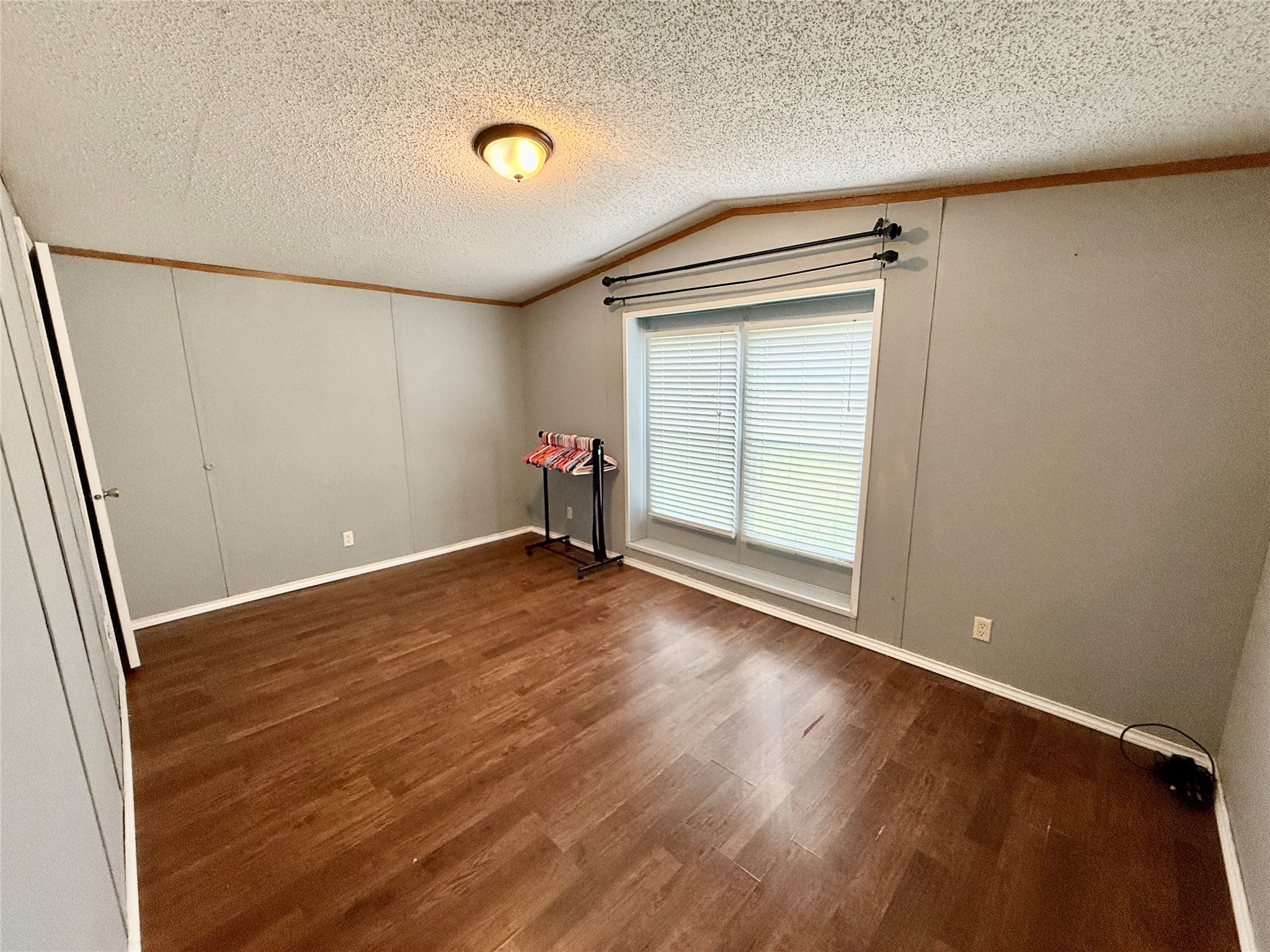 3075 FM 2001 Buda, TX 78610 - Photo 19 of 26 Third bedroom features wood-like flooring and a view of the outdoors.