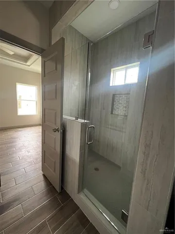 a bathroom with a glass door shower