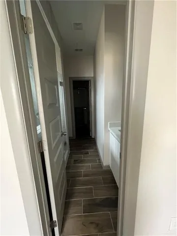 a view of a hallway with wooden floor and stairs