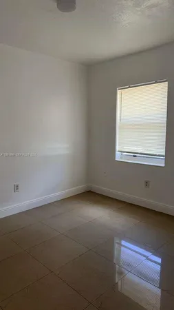 a view of a livingroom with an empty space and a window