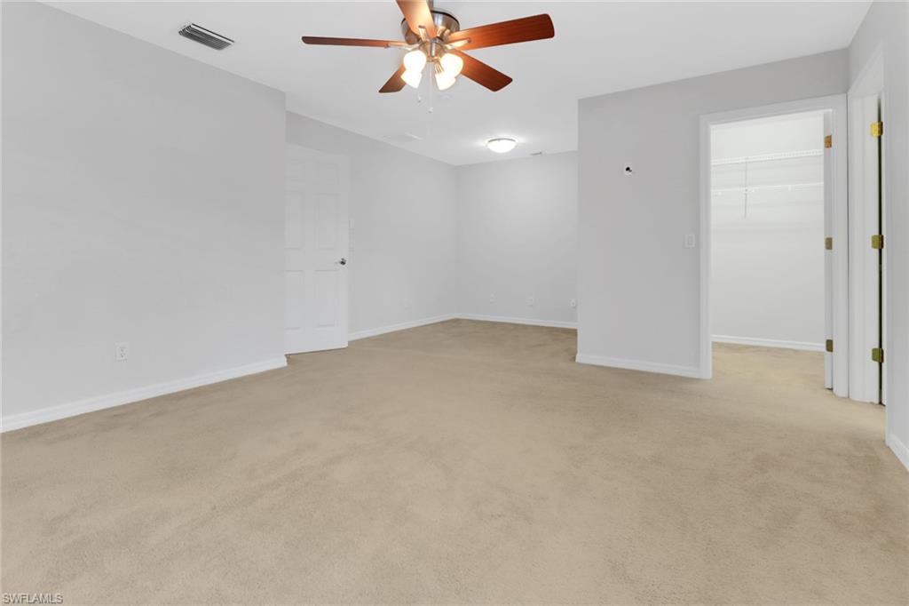 20000 Heatherstone Way, Unit 3 Estero, FL 33928 - Photo 18 of 44 a view of a big room with a ceiling fan