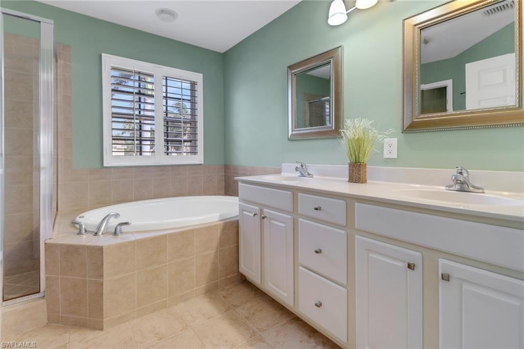 20000 Heatherstone Way, Unit 3 Estero, FL 33928 - Photo 21 of 44 a spacious bathroom with sinks mirror and bathtub