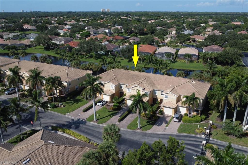20000 Heatherstone Way, Unit 3 Estero, FL 33928 - Photo 35 of 44 an aerial view of residential houses with outdoor space and parking
