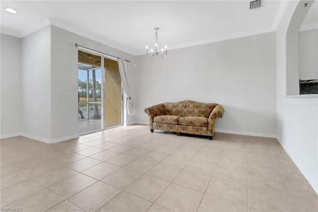 20000 Heatherstone Way, Unit 3 Estero, FL 33928 - Photo 10 of 44 a living room with furniture and a chandelier