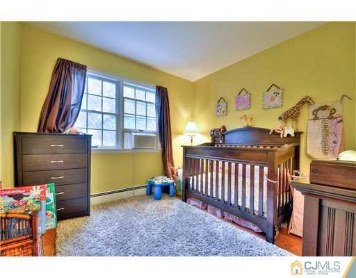 100 Winthrop Road Edison, NJ 08817 - Photo 11 of 18 a bedroom with a bed and wooden floor