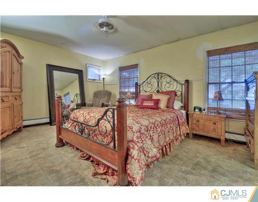 100 Winthrop Road Edison, NJ 08817 - Photo 12 of 18 a bedroom with a bed and a window