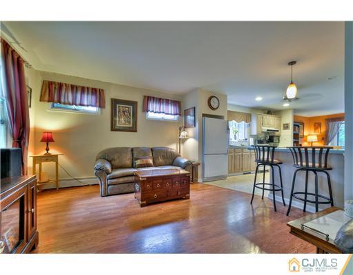 100 Winthrop Road Edison, NJ 08817 - Photo 4 of 18 a living room with furniture and a wooden floor