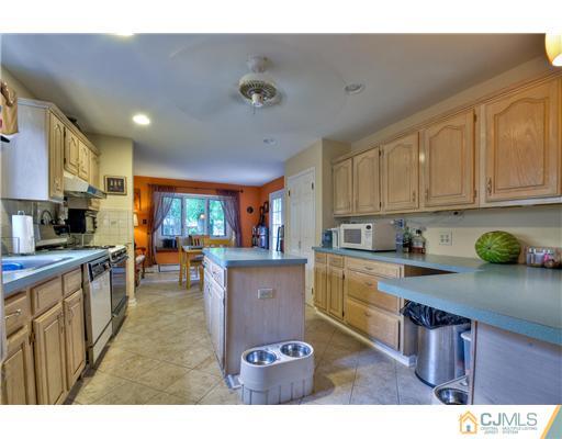 100 Winthrop Road Edison, NJ 08817 - Photo 7 of 18 a kitchen with stainless steel appliances granite countertop a stove refrigerator sink and cabinets