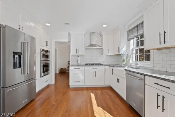a view of room with furniture and wooden floor