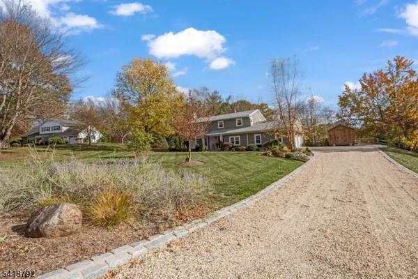 a living room with fireplace furniture and a large window