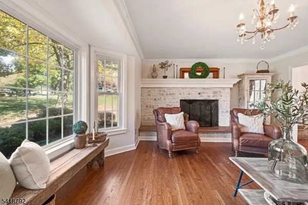 a view of a dining room with furniture wooden floor and chandelier