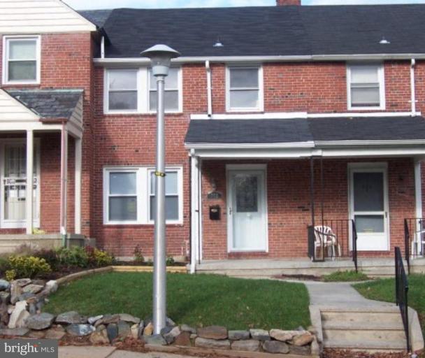 922 North Hill Road Baltimore, MD 21218 - Photo 1 of 14 front view of a brick house with a yard