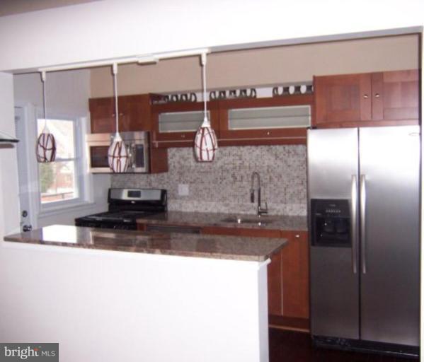 922 North Hill Road Baltimore, MD 21218 - Photo 4 of 14 a kitchen with a refrigerator and a sink