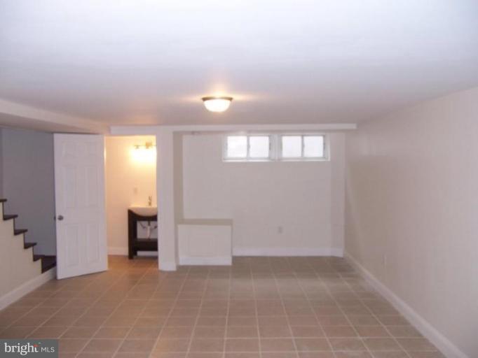 922 North Hill Road Baltimore, MD 21218 - Photo 7 of 14 wooden floor in an empty room with a window
