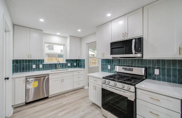 a kitchen with a stove and a microwave