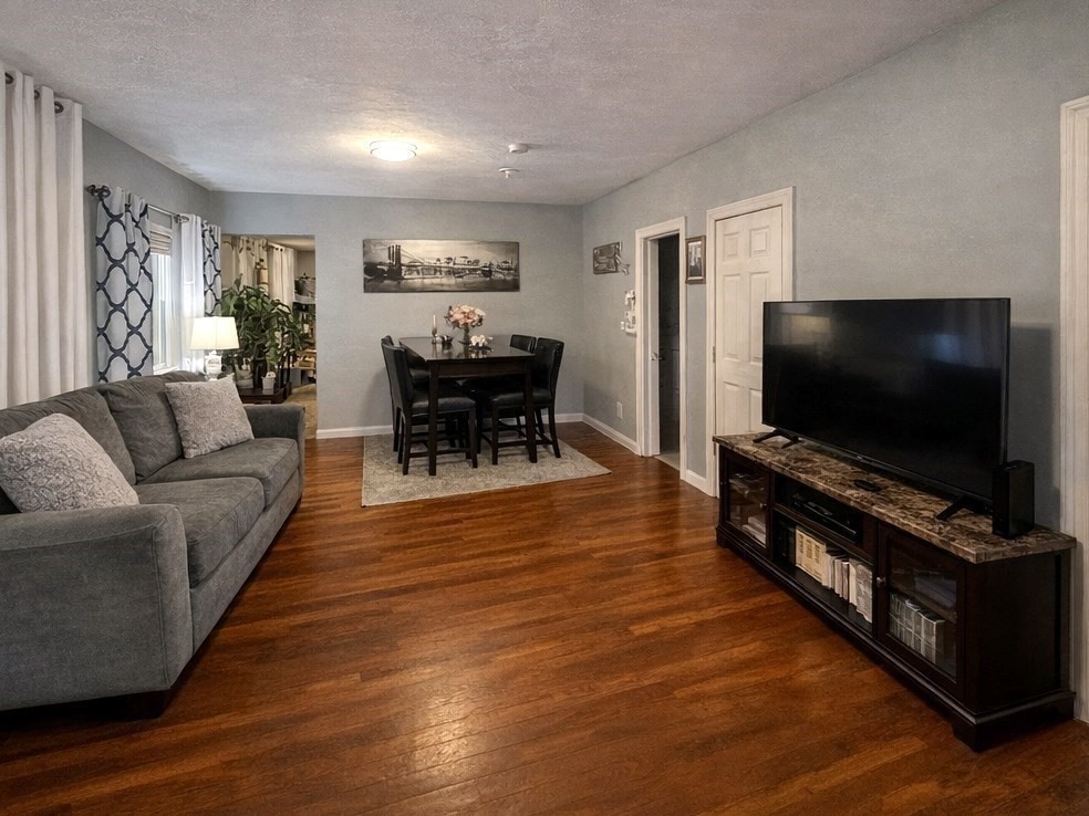 178 Cohasset Street, Unit 1 Worcester, MA 01604 - Photo 2 of 7 a living room with furniture and a flat screen tv