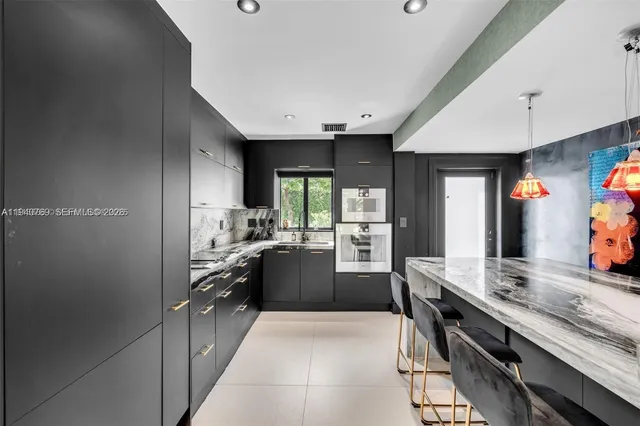 a kitchen with a sink appliances and cabinets