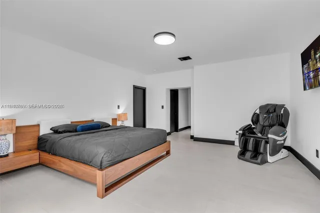 a bedroom with a bed and a chair in it